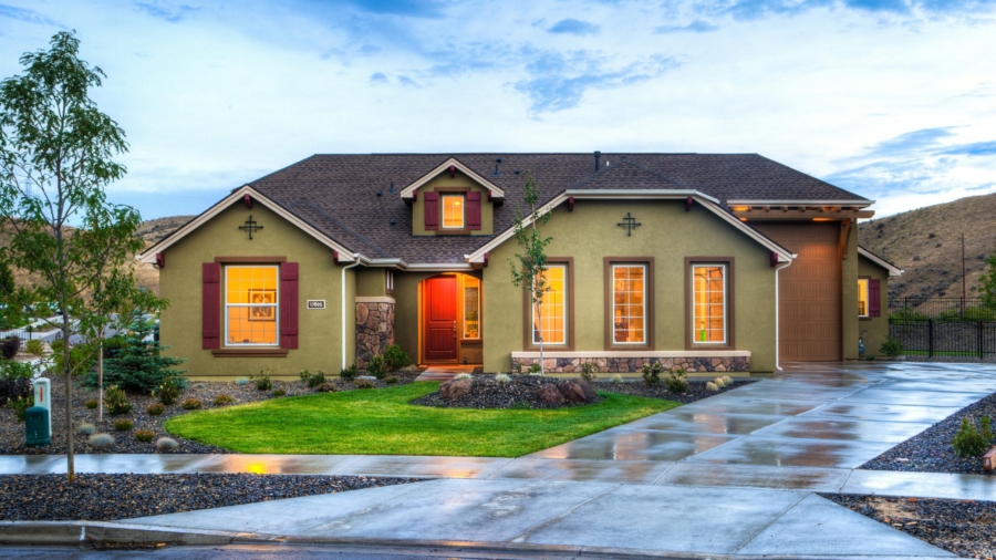 A professional real estate photographer capturing images of a modern house
