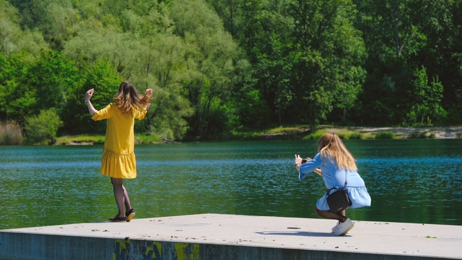 Photographer capturing a Candid Photography moment of a laughing child outdoors.