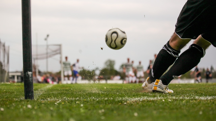 A beginner sports photographer capturing action during a soccer game.
