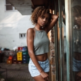 A stylish individual posing in an urban setting for a street fashion photography shoot